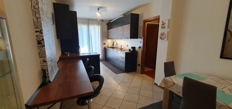 Kitchen seen from the breakfast bar, with a bright window